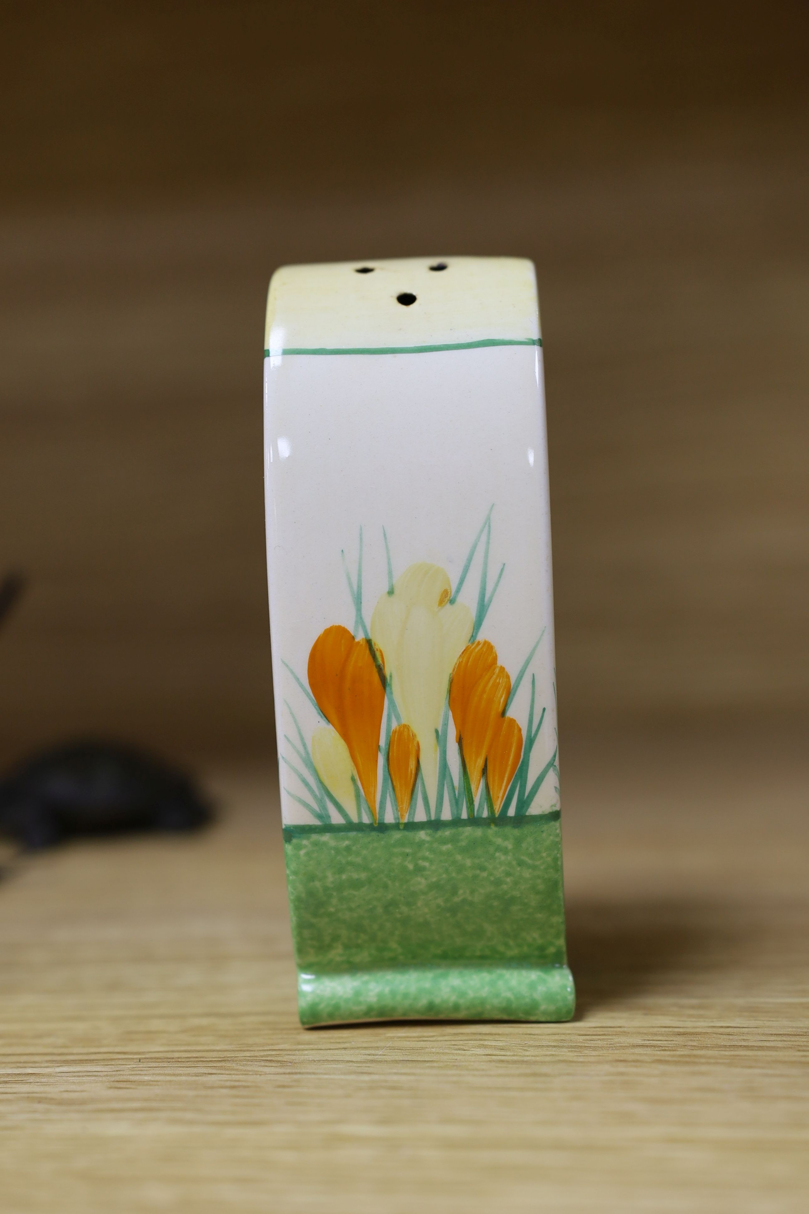 A Clarice Cliff sungleam crocus jam pot and cover, a sugar shaker and a Dutch clog ornament (3), jam pot and cover 10 cms high